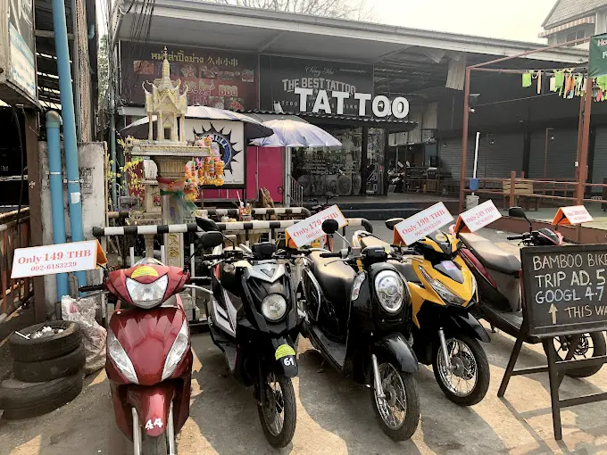 Scooters lined up outside Bamboo Bikes scooter rental in Chiang Mai.