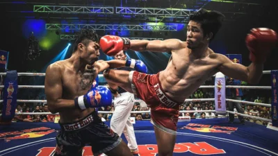 Two Muay Thai fighters exchange strikes during a live fight night in Chiang Mai.
