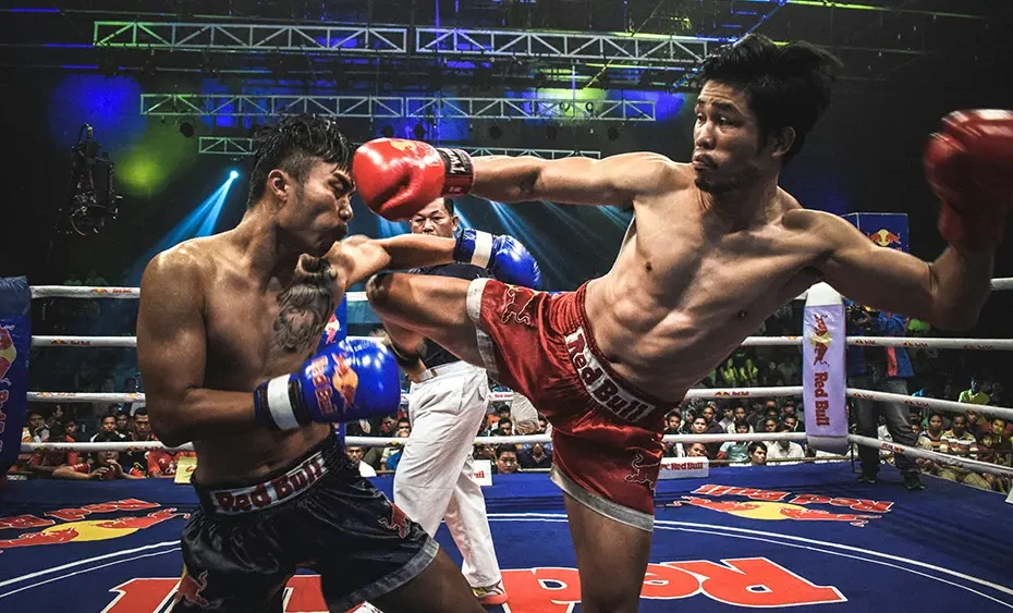 Two Muay Thai fighters exchange strikes during a live fight night in Chiang Mai.