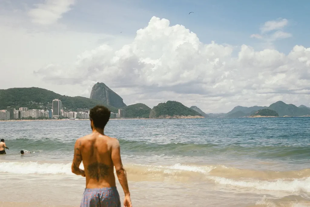 Man standing on a beach in Rio de Janeiro.