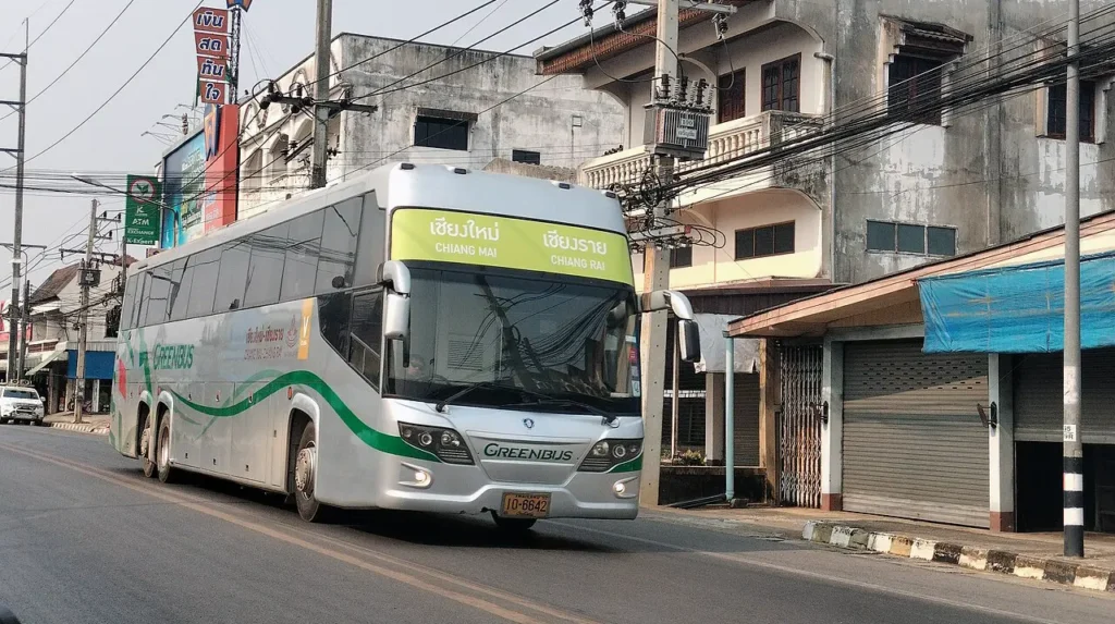 Greenbus driving on a street in Chiang Mai
